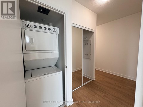 A white oven and stove top are in a kitchen area.