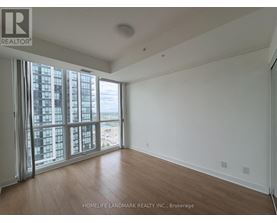 A room with a view of a cityscape through large windows.