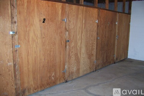 A wall of wooden lockers with the number 2 on the first one.