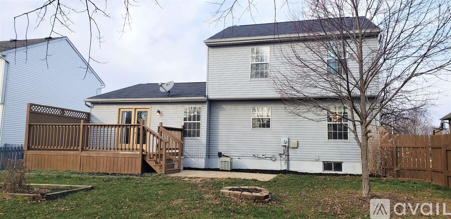 A house with a white exterior and a brown deck.