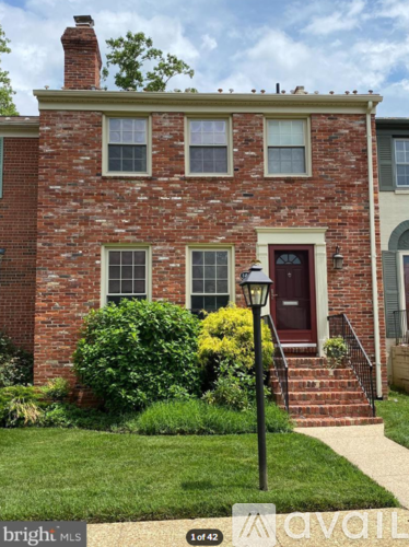 A red brick house with a black lamp post in front.