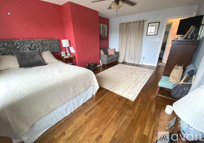 A bedroom with a large bed and a couch.