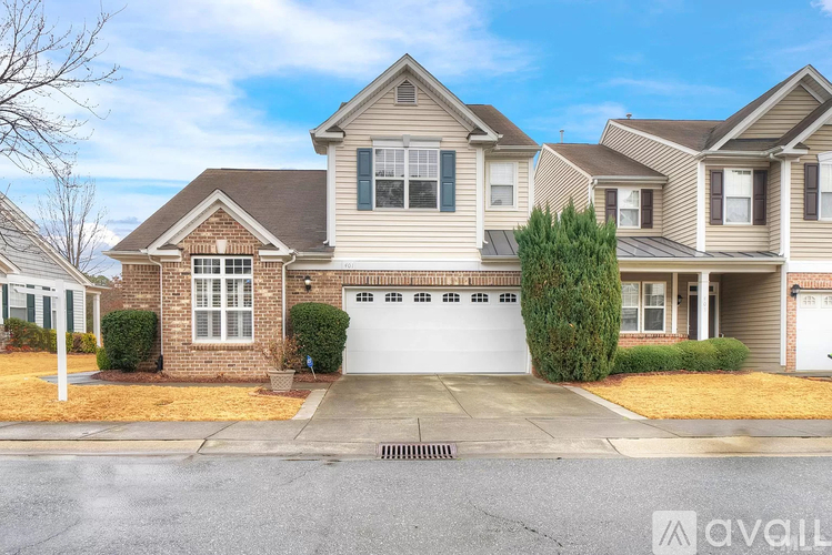 A large, two-story house with a garage is for sale.