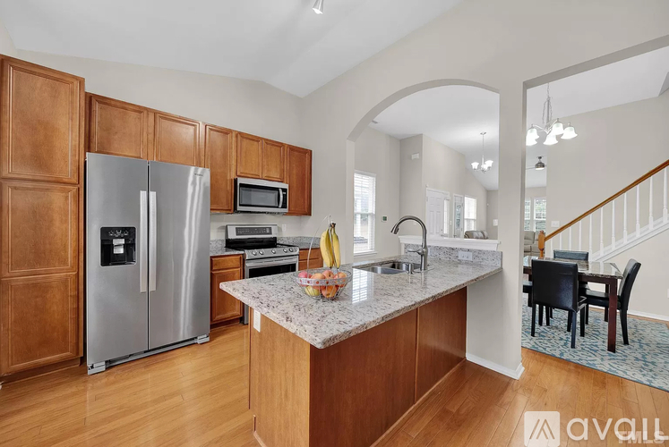 A kitchen with wooden cabinets and a granite countertop.