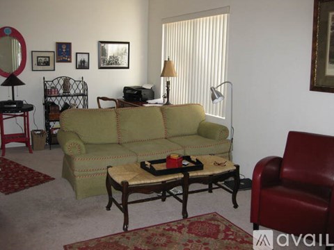 A living room with a green couch and a coffee table.