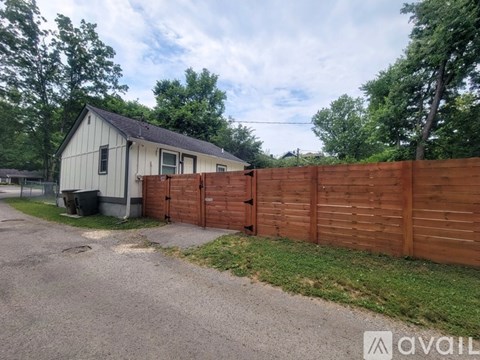A house with a wooden fence in front of it.