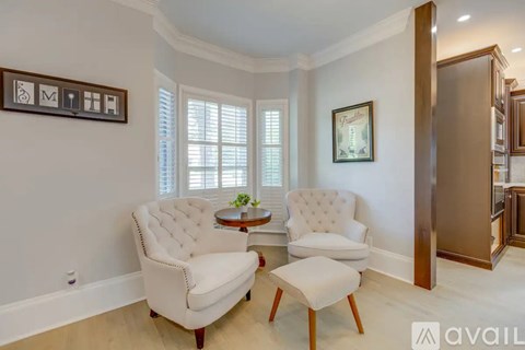 A living room with a white sofa and a wooden coffee table.