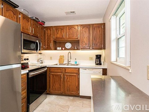 A kitchen with wooden cabinets and stainless steel appliances.