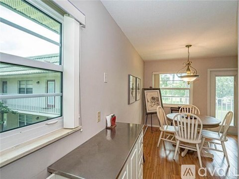 A dining room with a table and chairs.