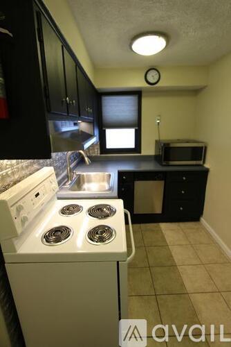 A small kitchen with a stove top oven and a microwave.