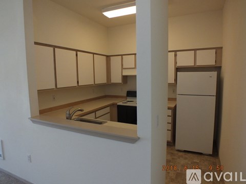 A kitchen with white cabinets and a counter top.