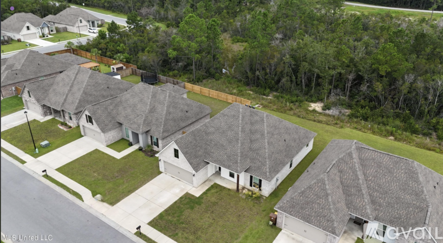 A row of houses with a white fence in the background.