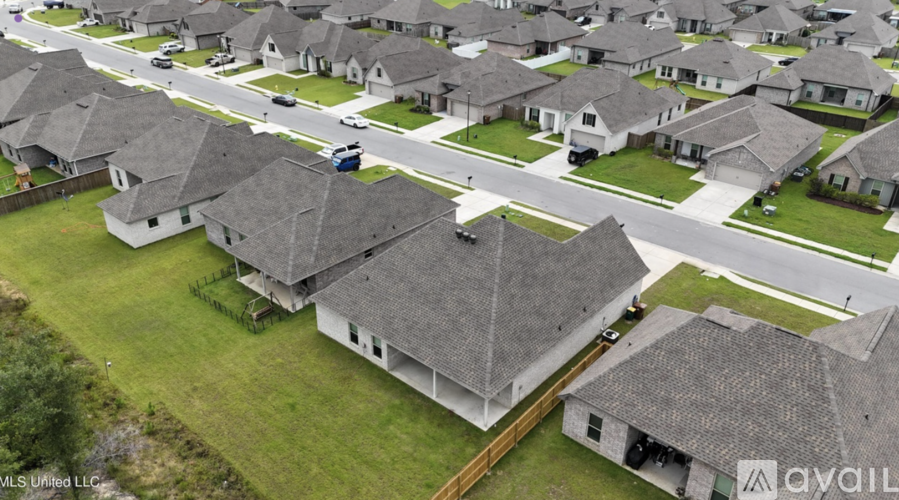 A row of houses with a grassy front yard.