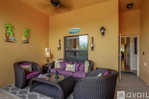 A living room with a sofa set and a fan.