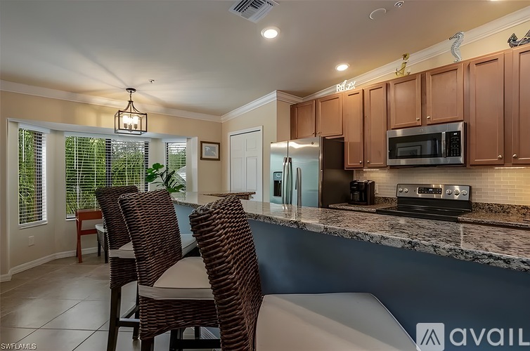 A kitchen with brown cabinets and a blue counter.