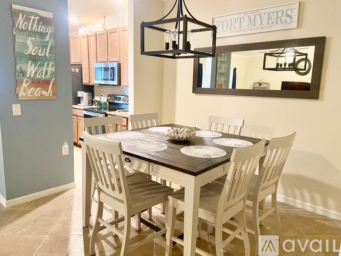 A dining room with a table set for four.