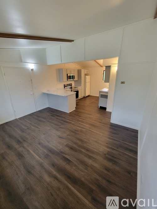 A room with wooden floors and white walls.