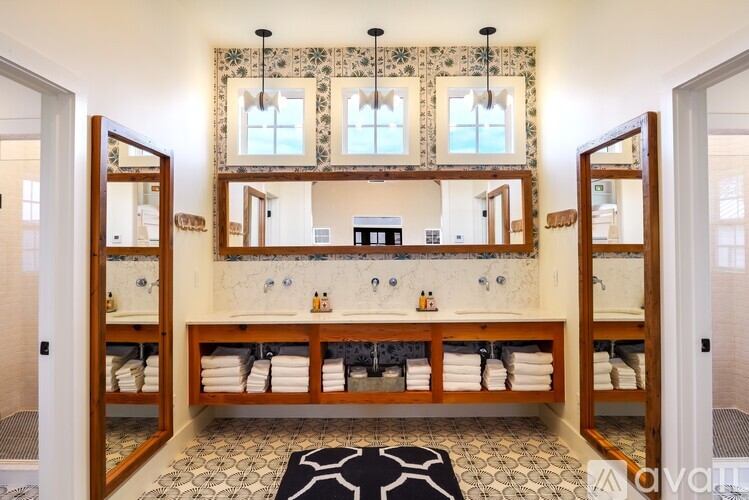 A bathroom with a vanity and mirrors.