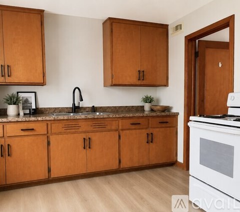A kitchen with wooden cabinets and a white oven.