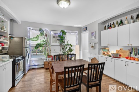 A kitchen with a table and chairs in the middle of the room.