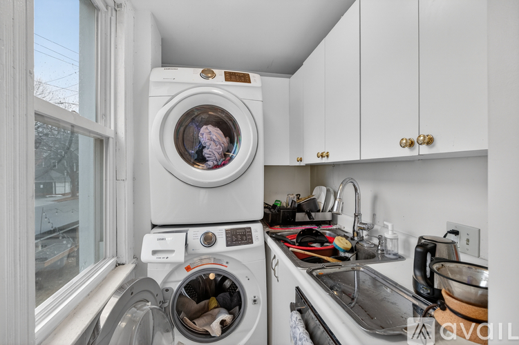 A washing machine is on the left and a sink is on the right.