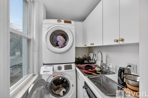A washing machine is on the left and a sink is on the right.