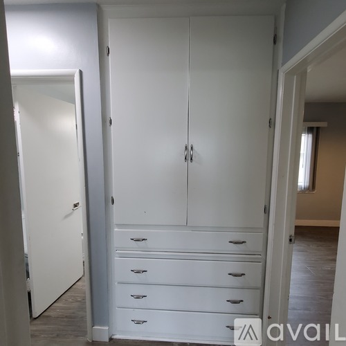 A white wardrobe with drawers is available for rent.