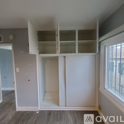 A room with a white cabinet and a window.