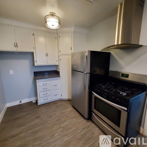 A kitchen with a stove and refrigerator.