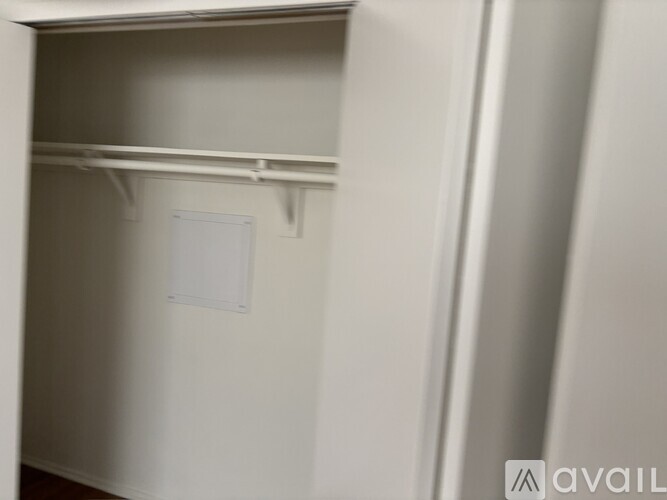 A white door with a handle is open.