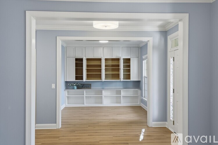 A spacious room with a built-in bench and shelves.