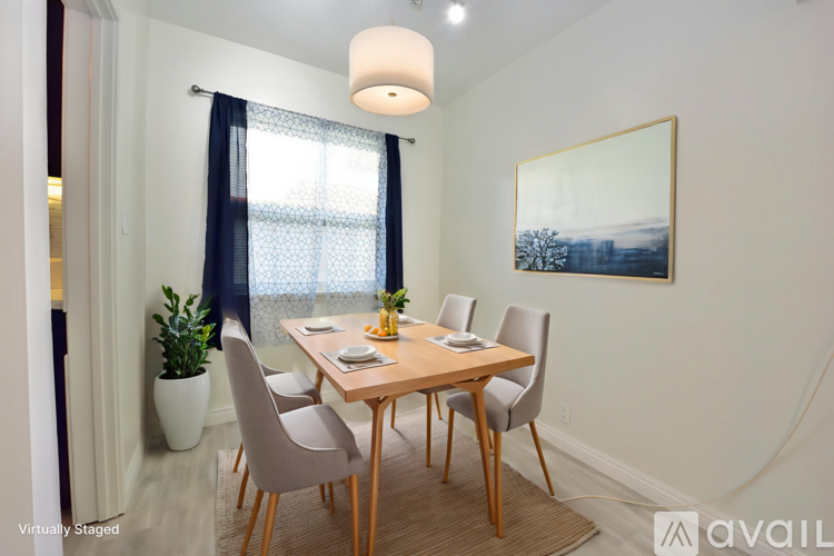 A dining room with a wooden table and chairs.