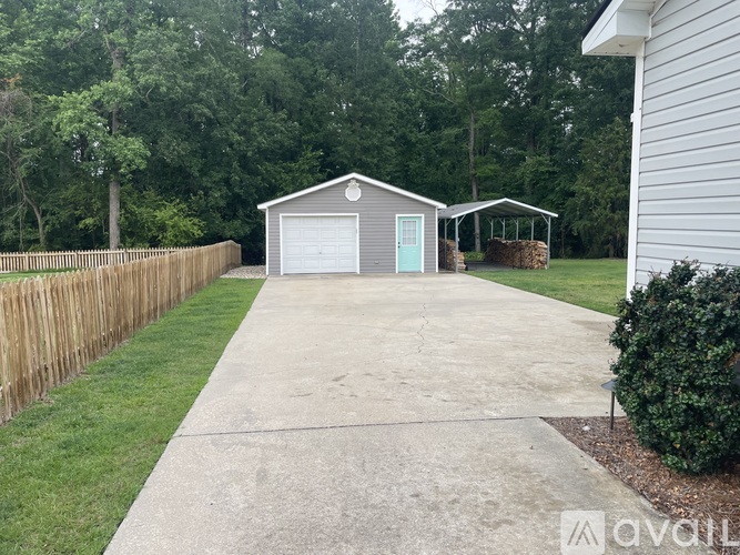 A house with a garage and a driveway in front of it.
