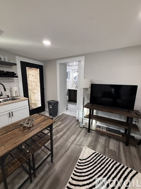 A living room with a television and a wooden table.