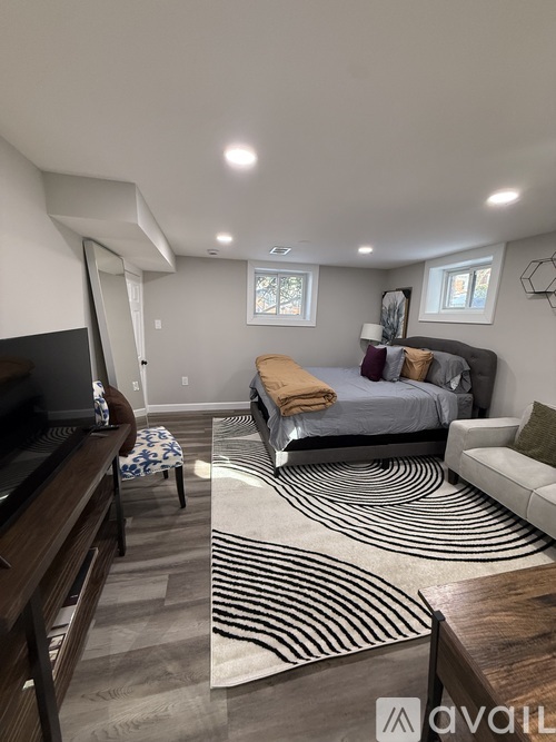 A modern bedroom with a large bed and a television.