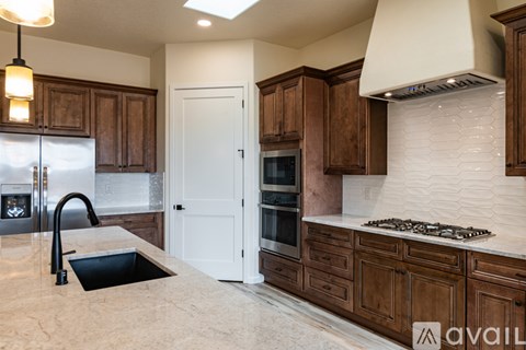 A kitchen with brown cabinets and a white door.
