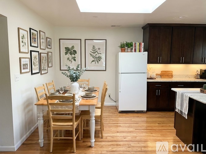 A dining room with a table set for a meal.