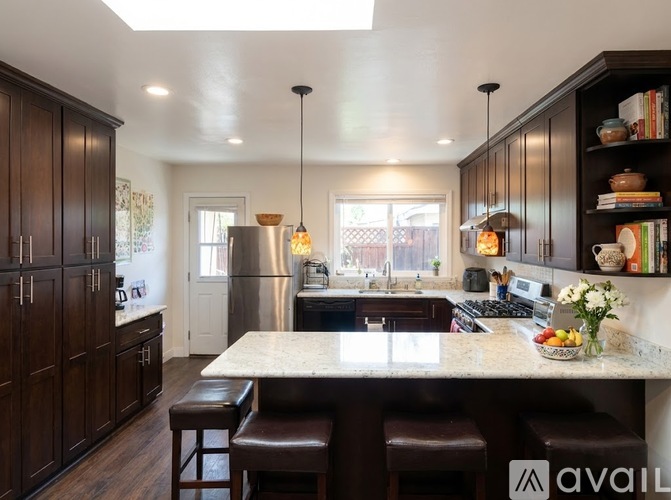 A kitchen with dark wood cabinets and a central island.