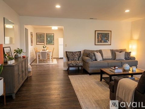 A living room with a grey couch and a coffee table.