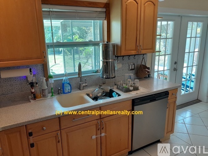 A kitchen with wooden cabinets and a white countertop.