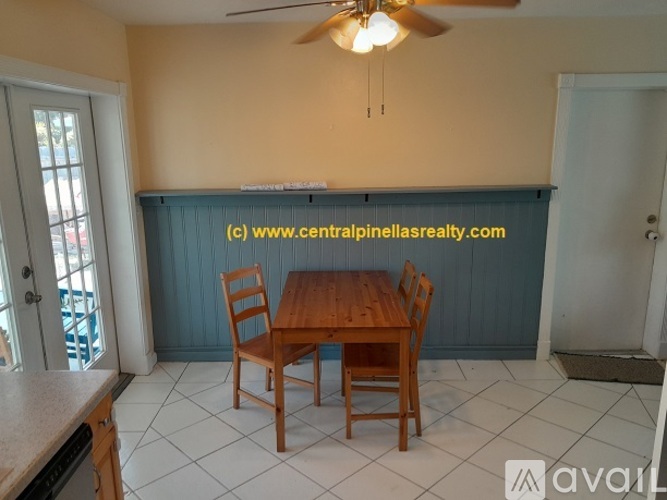 A dining room with a wooden table and chairs.
