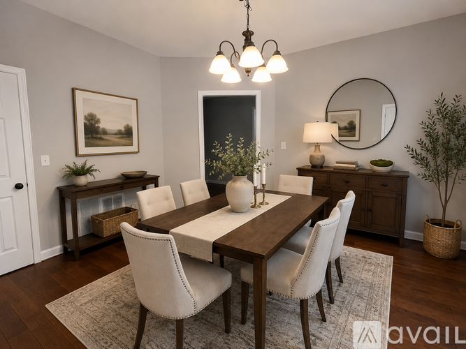 A dining room with a wooden table and chairs.