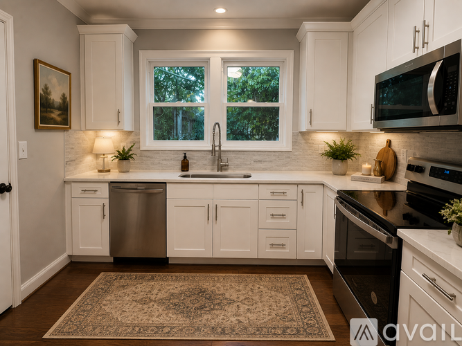 A kitchen with white cabinets and a rug on the floor.