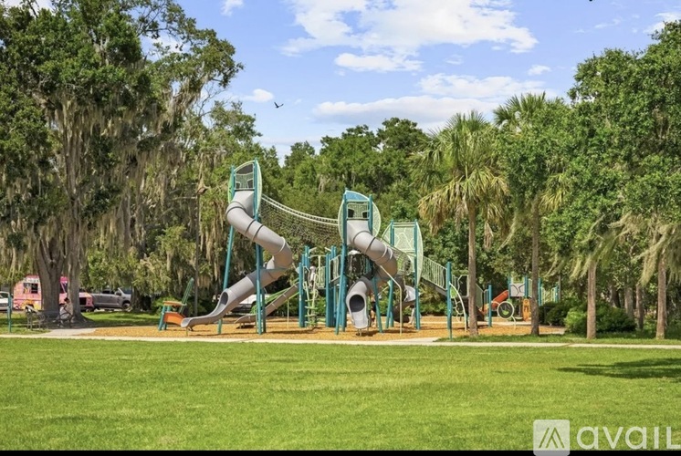 A playground with a green slide and a yellow slide.