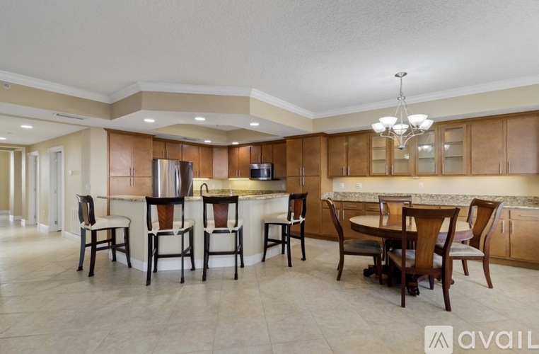 A kitchen with a table and chairs in the middle of the room.