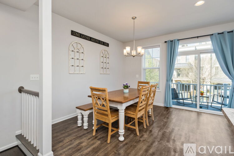 A dining room with a wooden table and chairs.