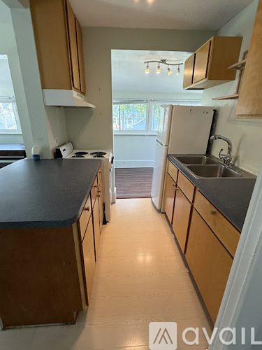 A kitchen with wooden cabinets and a black countertop.