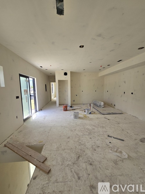 A room under construction with a lot of debris on the floor.