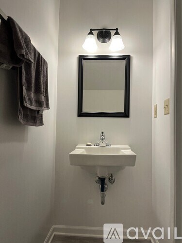 A bathroom with a white sink and a mirror above it.