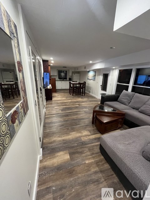 A living room with a grey couch and a wooden coffee table.